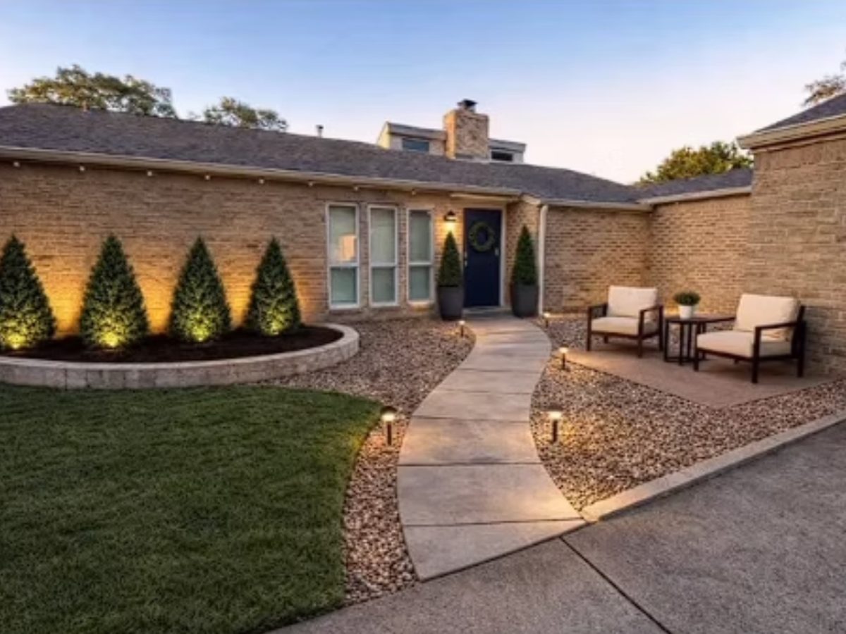 Front yard upgrade with curved walkway and landscape lighting in Houston